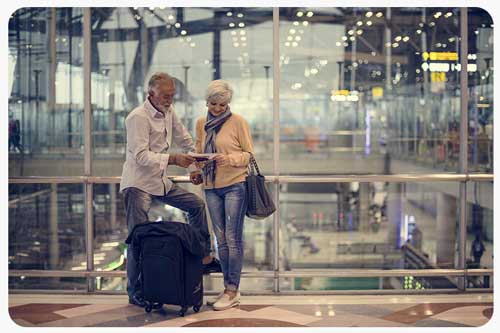 senior couple at ariport looking at travel documents