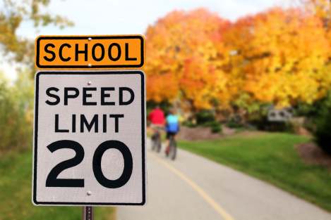 sign displaying 20/km in community safety zones