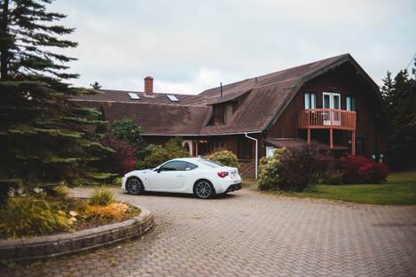 white car parked outside house