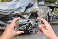 Person documenting accident with photos