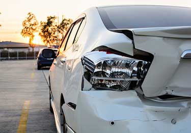 Damaged rear end of white car