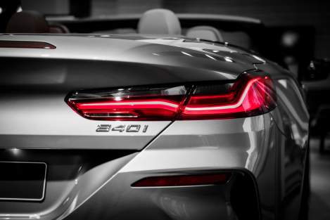 Man with beard looking at a car