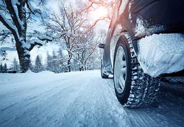 Tires on a SUV driving on snowy road