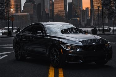 black bmw parked in the city