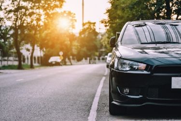 black car parked on the side of a road