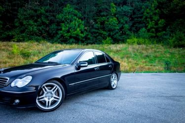 black sports car forest background