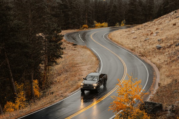 car driving in country road in fall