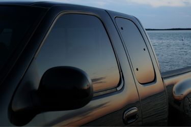 black truck with sunset reflecting on windows