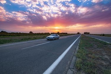 car driving with pink sunset