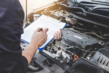 mechanic doing checking over a car