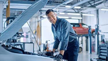 A mechanic doing car maintenance in a garage