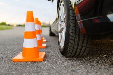 car parked beside orange pylons