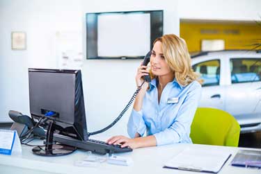 Woman working in car dealership service department