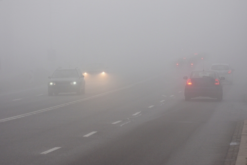 Cars driving on highway in fog