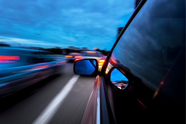 cars speeding during the dusk 