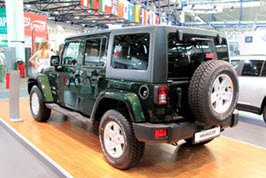 Green Jeep Wrangler in a showroom