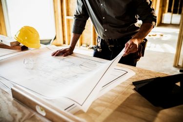 man looking at construction designs