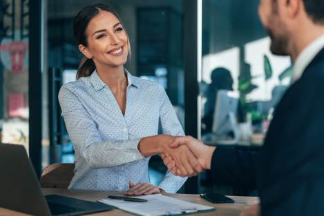man and woman shaking hands in a office