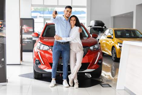 couple buying red car