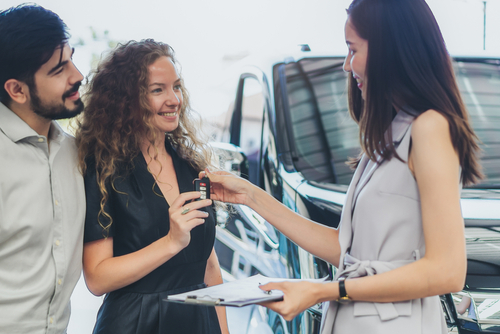 Couple at a used car lot