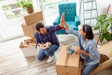 couple high-fiving on moving day