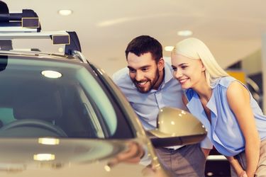 couple looking at a vehicle