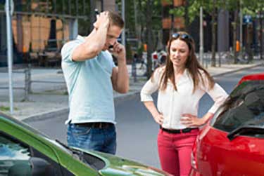 Man and woman at intersection after car accident