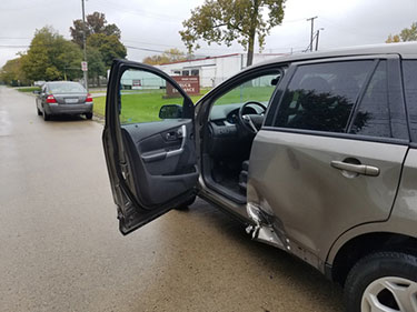 Grey SUV with damaged rear door