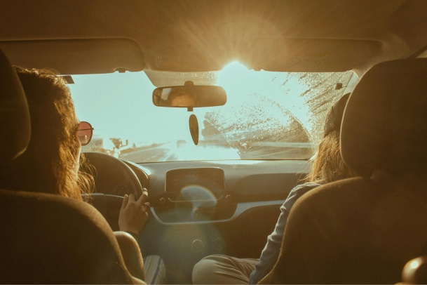 two women driving at golden hour