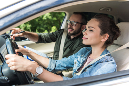 Driving teacher with female student