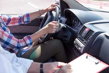 student taking road driving test