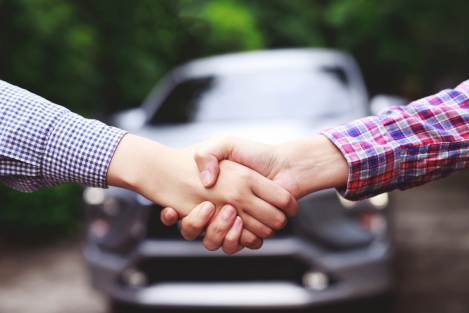 handshake infront of car
