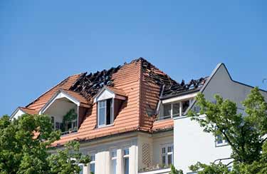 damaged roof of house after a fire