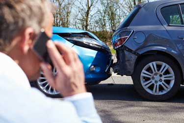 Man on phone after an auto accident