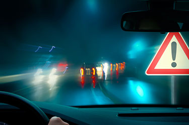 Person driving at night in the rain