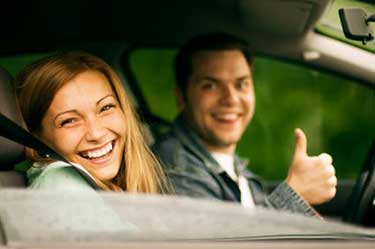 young happy couple in a car