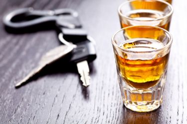 car keys beside shot glasses with alcohol