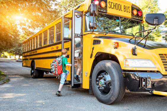 kids getting on a school bus