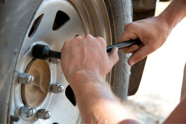 Man changing tire outside