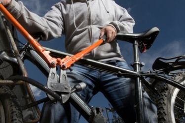 Man cutting a lock on a bike