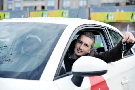 Man driving new used car off lot