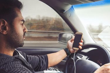 man on phone while driving