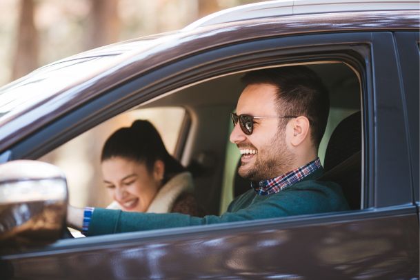 Married couple driving vehicle