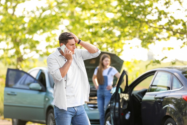 man calling insurance company after an accident