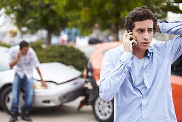 Driver making a phone call after an accident