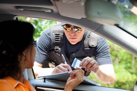 officer giving ticket to driver