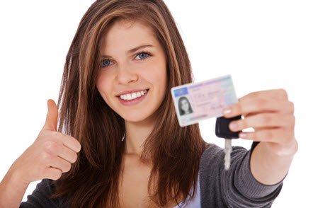 Teenage girl showing her drivers licence and car keys