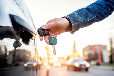 man unlocking car with key