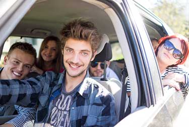 Teenage boy driving with friends