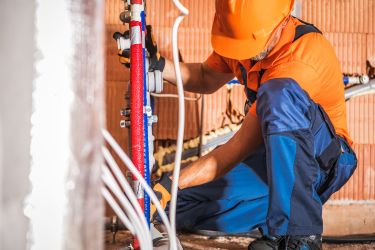 plumber working on pipes